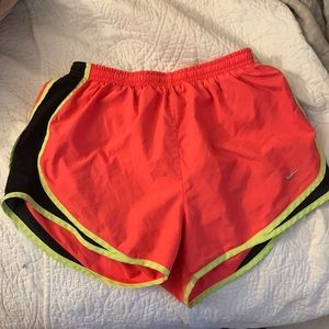 Nike dry-fit shorts, size medium. Pink with neon yellow and black sides